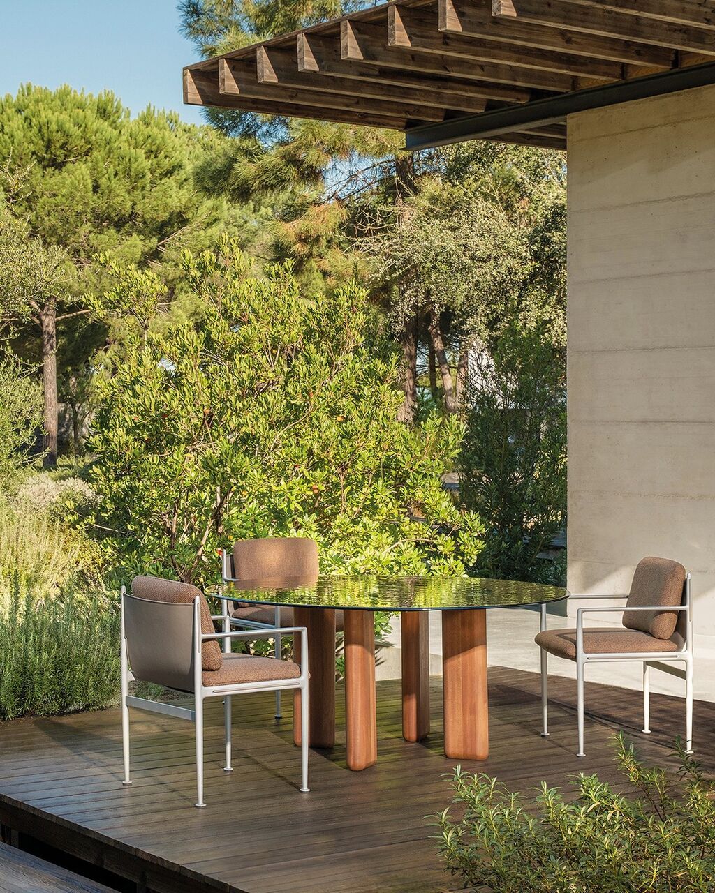 Oval and round Leku dining tables sport egg-shaped fused glass tops resting on robust FSC certified sapele legs