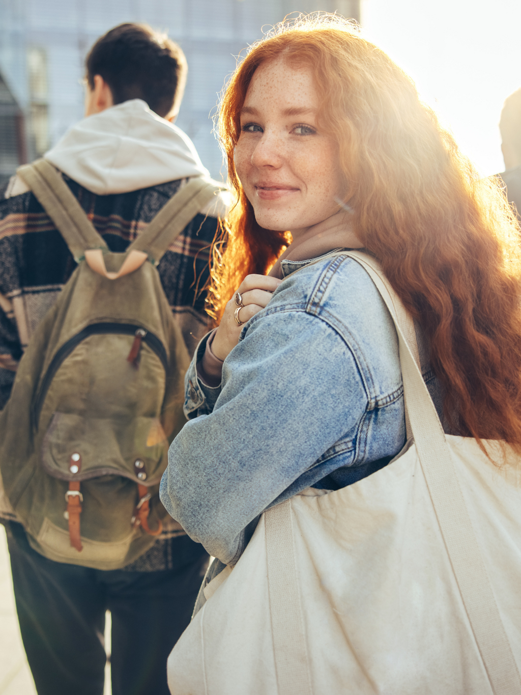 Preview image of a teen smiling while walking into school with friends. Click to get the facts about underage drinking.
