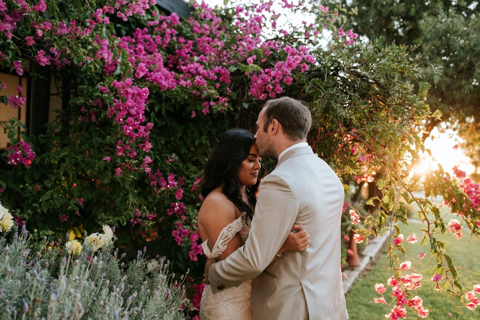 Lulu and Brendan tucked away in the cascading pink bougainvillea at Hastwell & Lightfoot