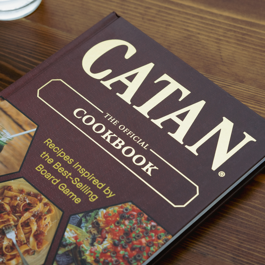 CATAN Cookbook and apron